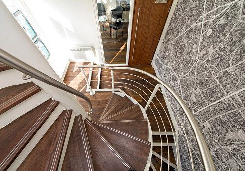 stainless steel handrail on a wood and steel spiral stair