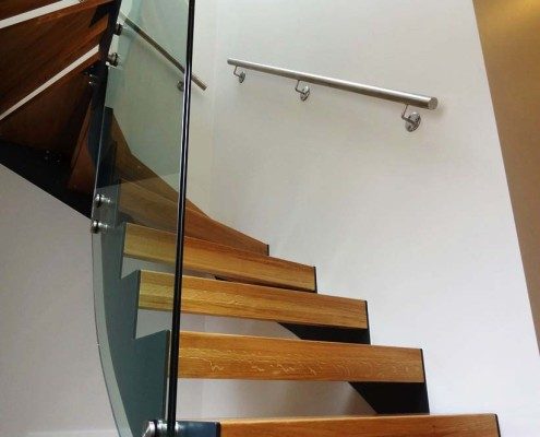 half turn steel staircase with wooden steps and open risers