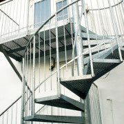 platform and spiral stair to the back of a white building