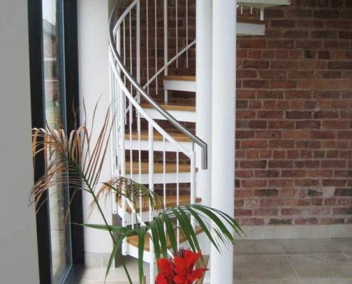 red floor in front of a white spiral staircase