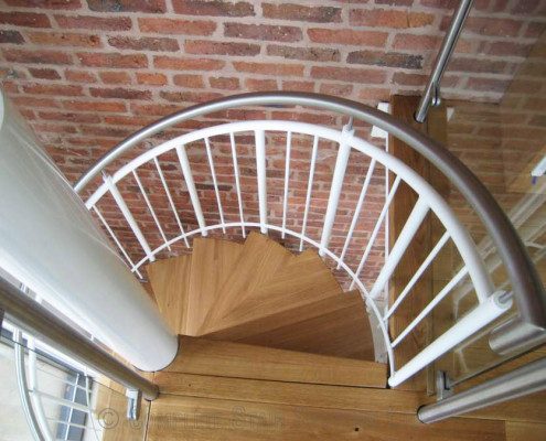 Spiral Stainless steel handrail on a spiral staircase with white spindles