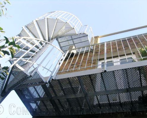 double flight spiral staircase to the rear of a house