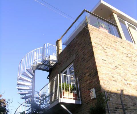 platform and spiral staircase to the side of a house