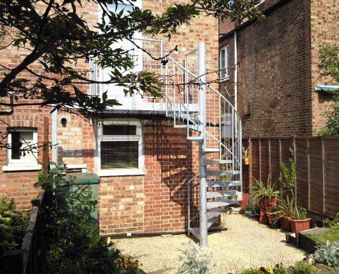 spiral stair and platform to rear of brick building