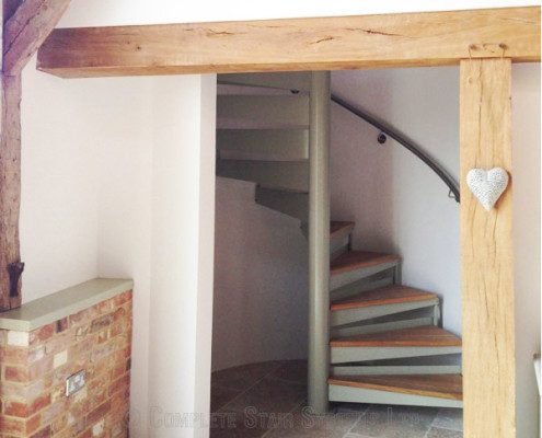 oak beam framing a spiral staircase with oak steps