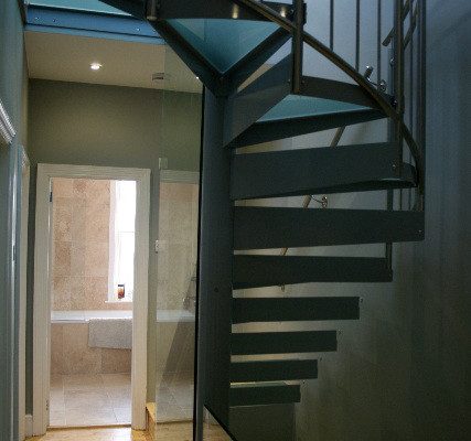 steel loft spiral stair with glass treads