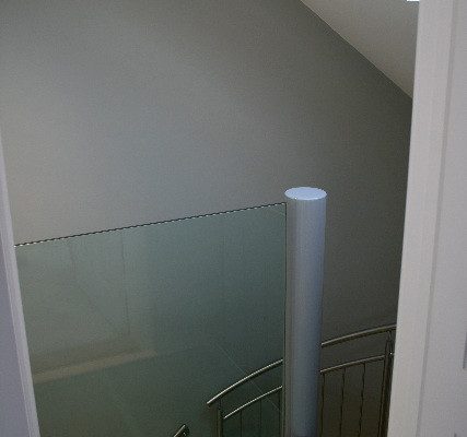 glass platform and panel at the top of a steel staircase