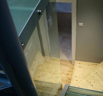 glass treads and panel on a steel staircase