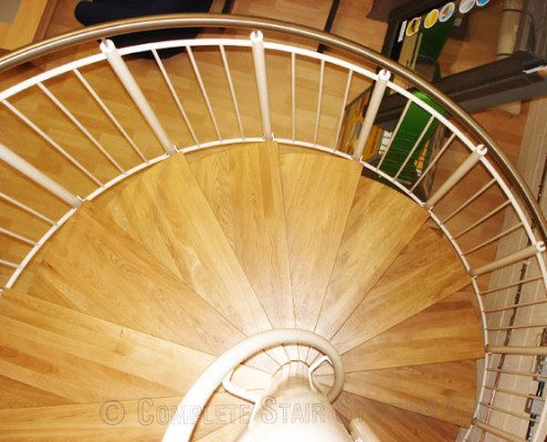 oak steps on a white spiral staircase