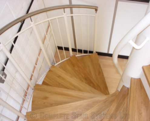 oak steps on a white spiral staircase
