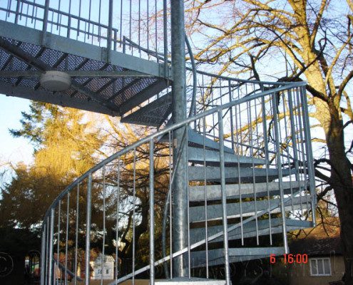 Galvanised spiral staircase in a wood