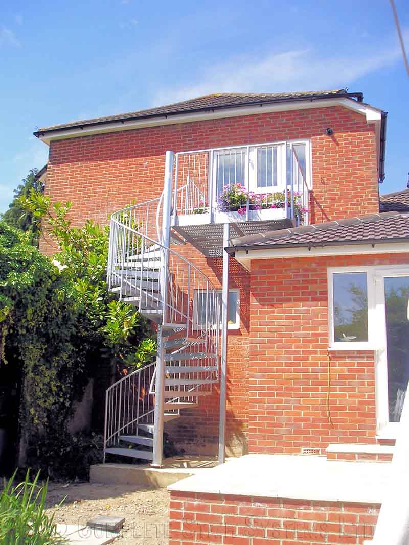 Bespoke Spiral Staircase Southampton - External Spiral 1 red brick house with spiral staircase and balcony