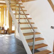 white steel stair with open risers staircase on a dark grey floor