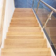 looking down an oak and glass staircase