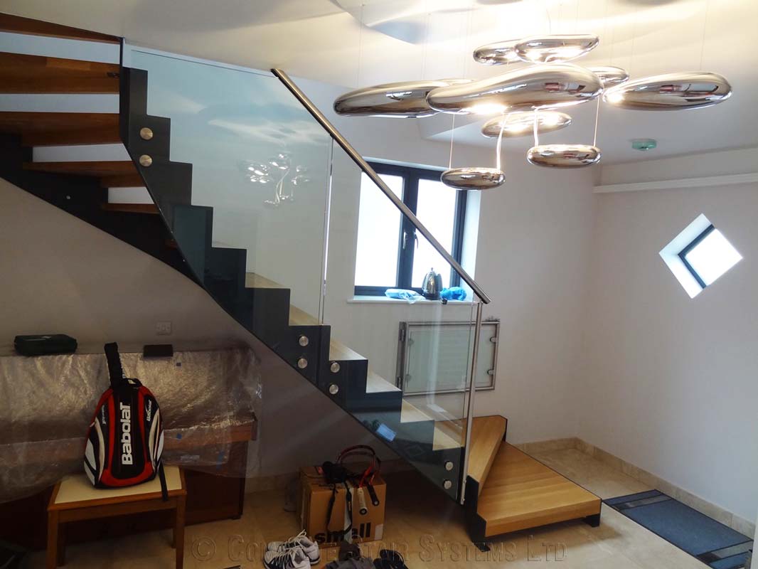 Bespoke Staircase Chiswick - Model 500 -5 black steel stringer staircase with large glass panels to side