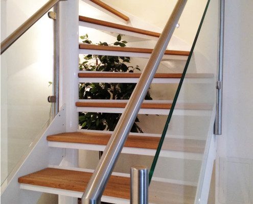 open riser white steel spiral stair with stainless handrail