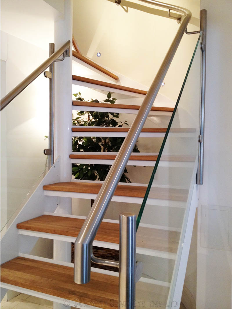 open riser white steel spiral stair with stainless handrail