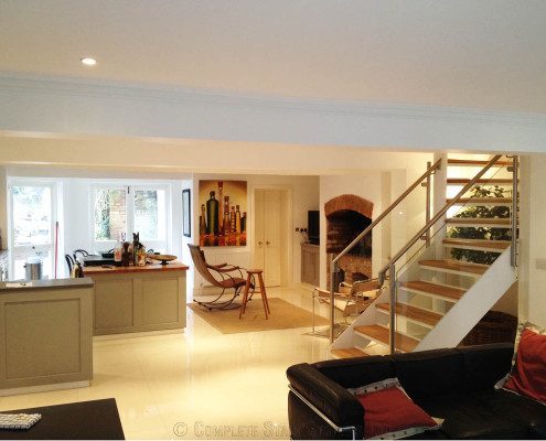 kitchen dining area with glass and steel staircase