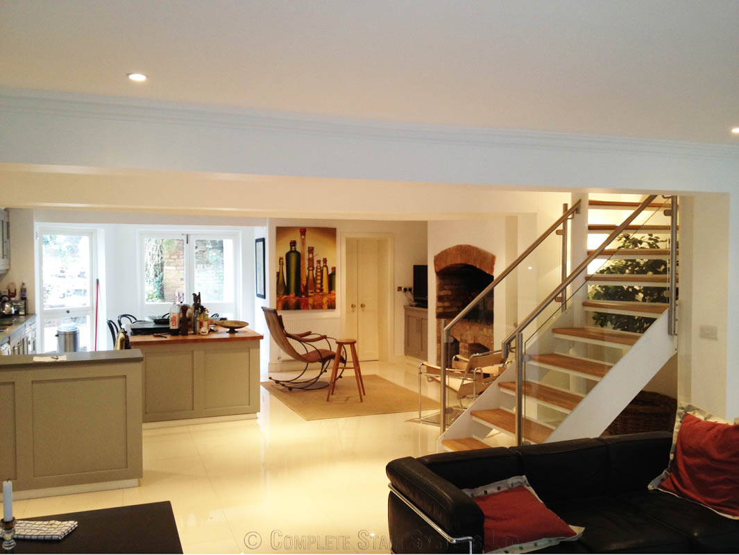 kitchen dining area with glass and steel staircase