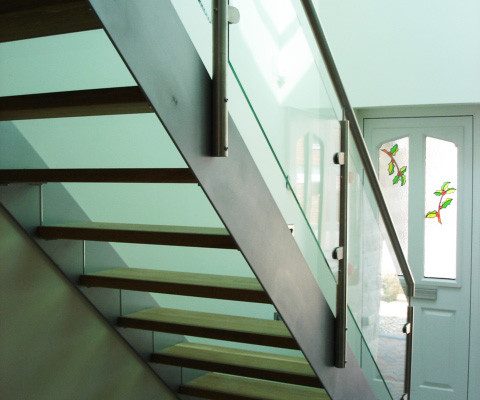 grey steel stringers to side of stair in a hallway