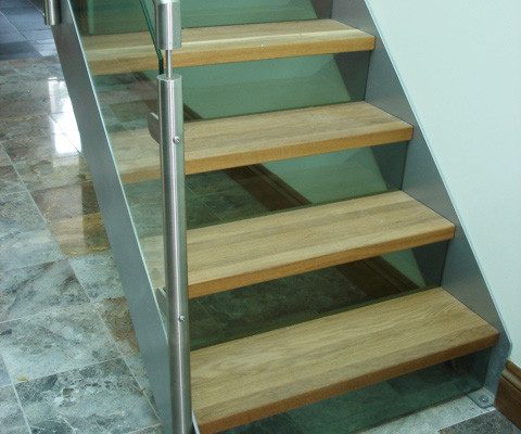 tiled floor below a modern steel and glass staircase
