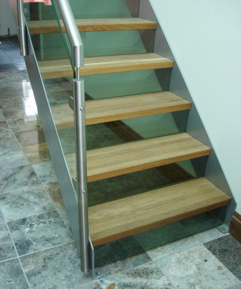 tiled floor below a modern steel and glass staircase
