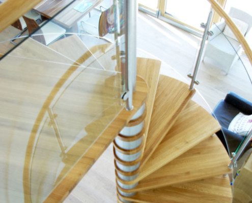 oak spiral staircase with glass panels wrapping