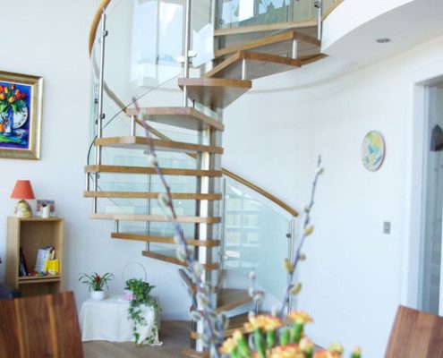living area with dining table and spiral stair to rear