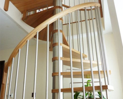 stainless steel spindles on a oak step spiral staircase