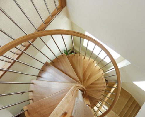 looking down on an oak spiral stair with stainless steel spindles