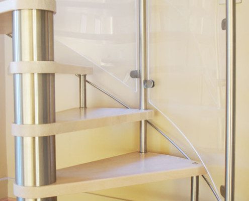 curved glass panels on a spiral stair with stainless steel posts