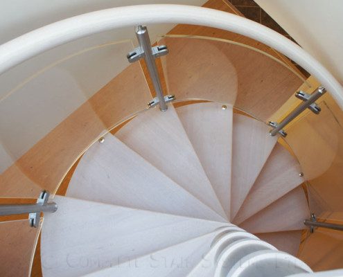 looking down on light wooden steps on a spiral staircase