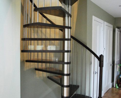 dark wood spiral staircase with stainless steel centre column