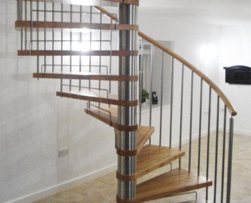 oak tread spiral staircase on a tiled floor in a house