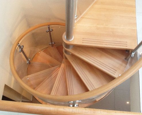 spiral staircase with timber steps and handrail
