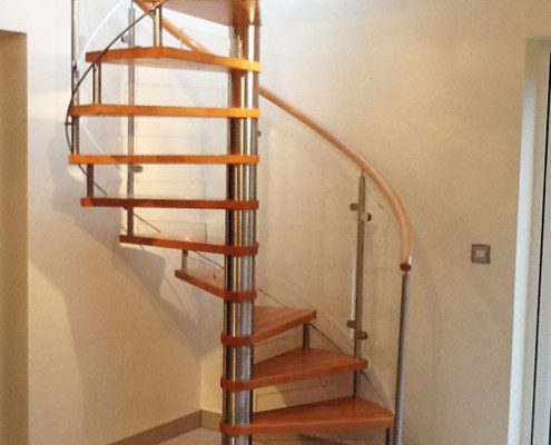 tiled floor in a house with spiral staircase with open risers