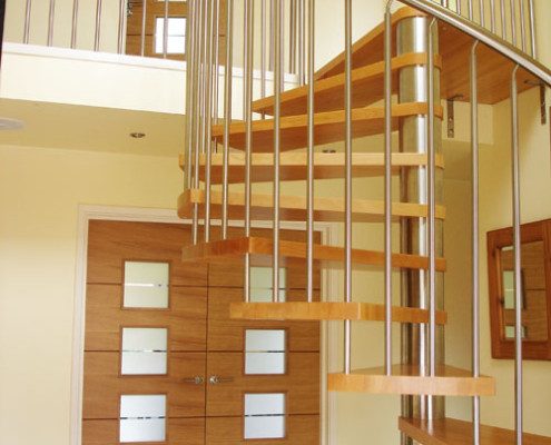 hallway with timber doors and spiral staircase with stainless handrail