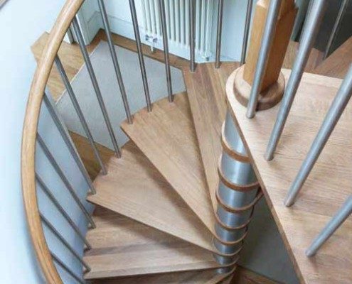 circular hole in floor with a spiral staircase