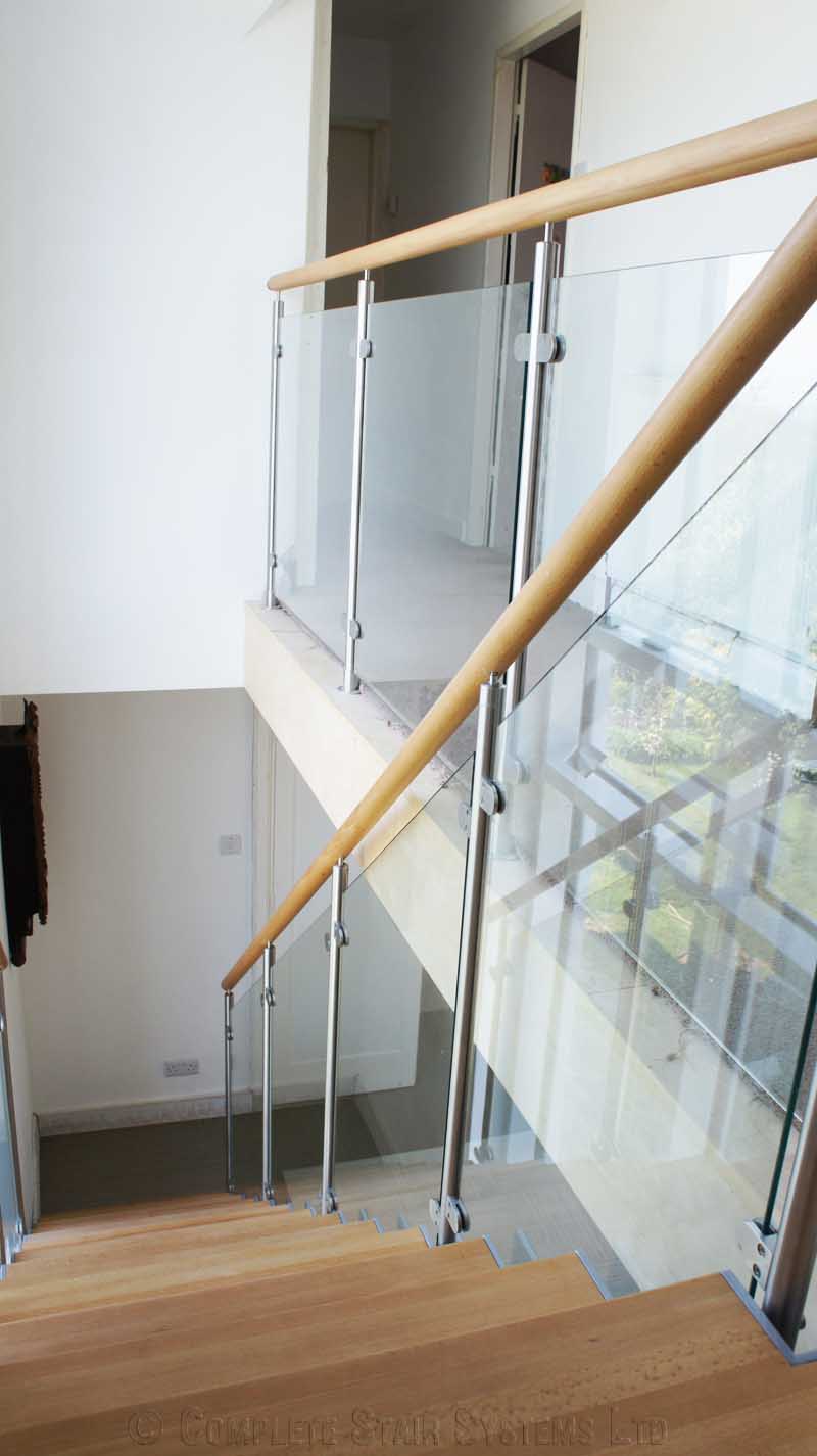 Bespoke Staircase Haslemere - Model 500 glass panels on landing over stairwell