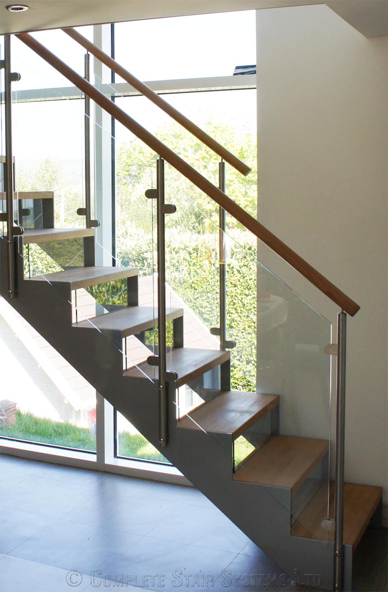 Bespoke Staircase Haslemere - Model 500 side glass panels on staircase with steel stringers