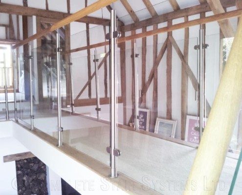 walkway with glass panel to both sides in a timber frame building