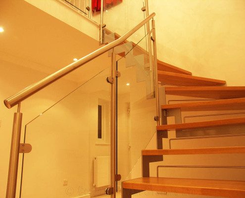 open riser staircase with glass infill panels to side
