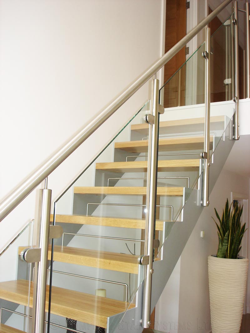 Bespoke Staircase Poole - Model 500 glass panels to side of modern stair with stainless handrail