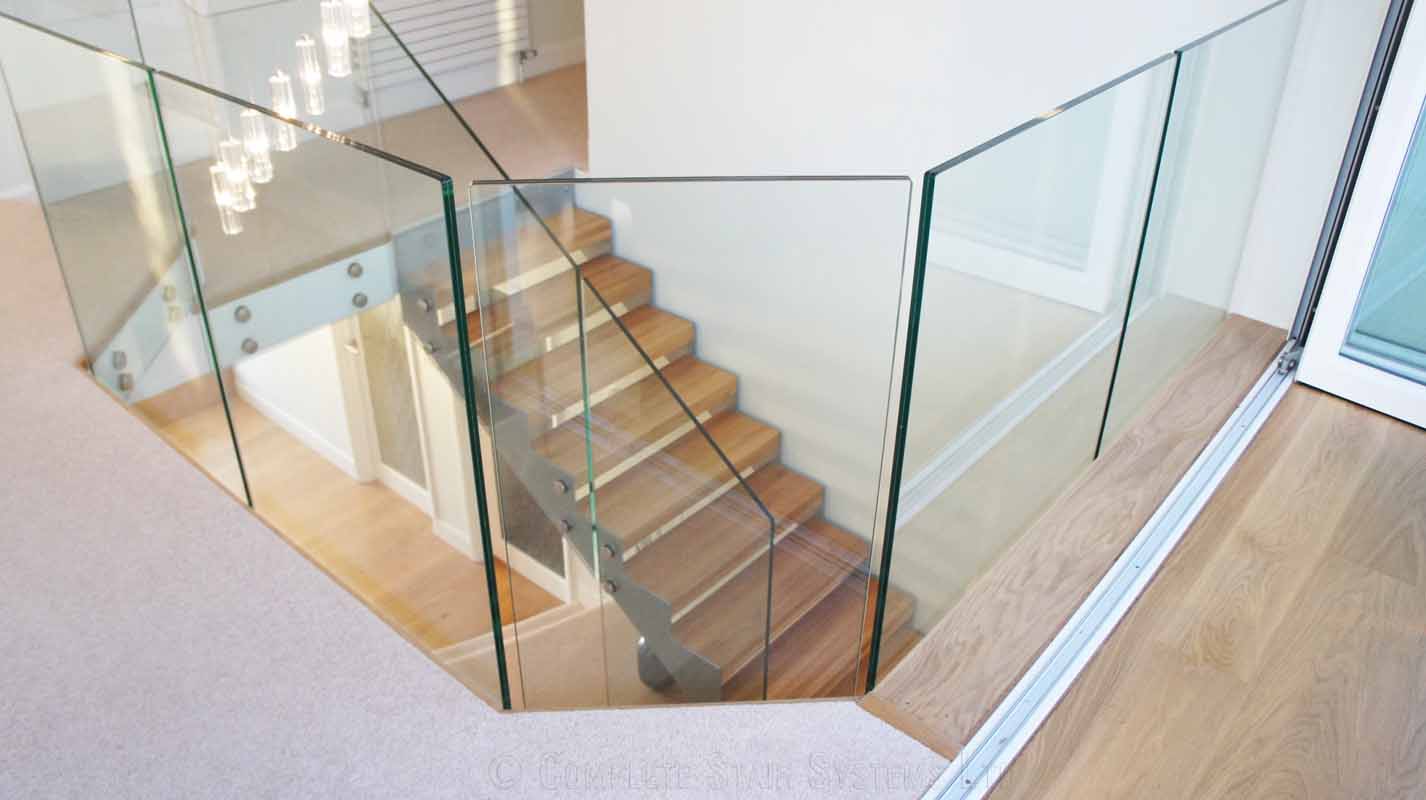 Bespoke Staircase Southampton - Model 500 glass panels around an opening featuring a oak and steel staircase