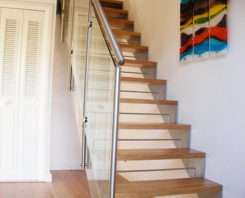 glass panels to the side of a staircase in a house