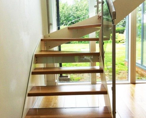 large window behind an open riser steel and glass stair