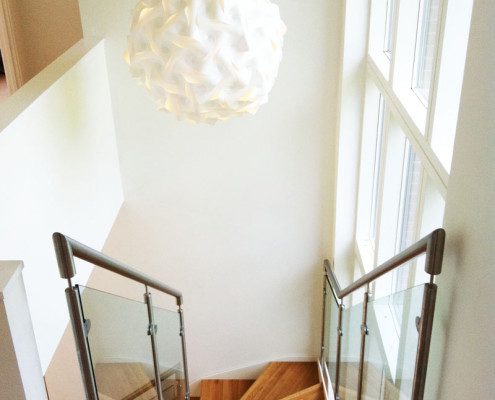 designer white ball light above a staircase in a stairwell
