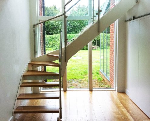 timber floor in front of a large window with garden beyond
