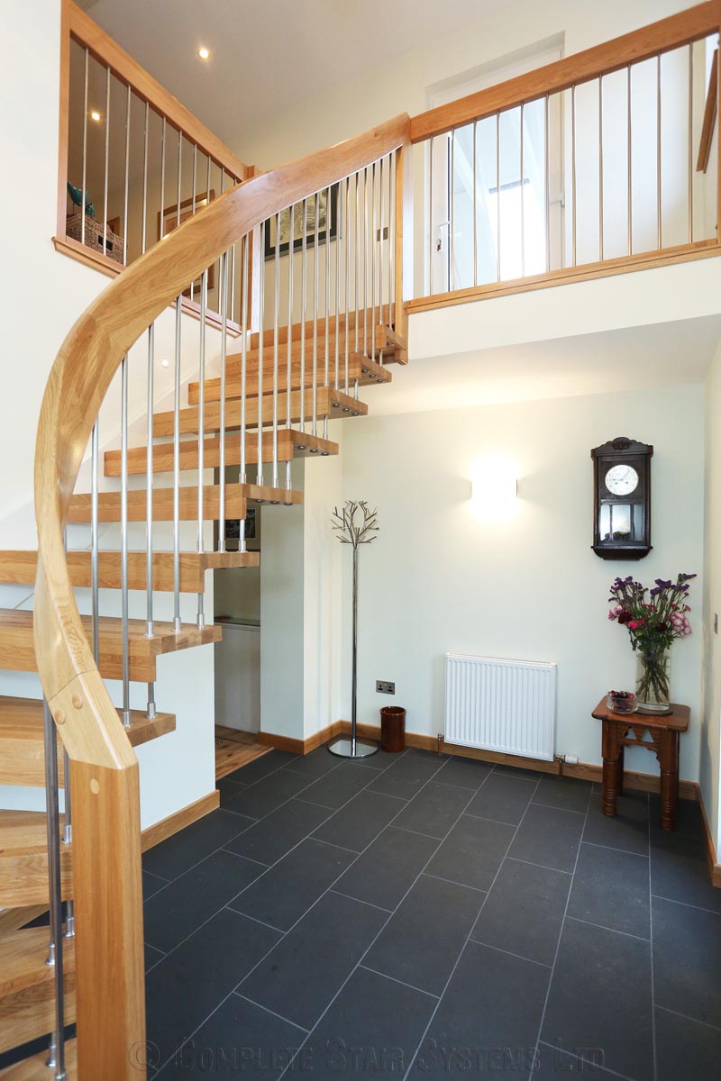 Bespoke Timber Staircase - Aberdeen hallway with black floor and floating timber staircase