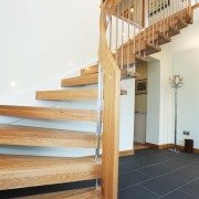 curved handrail on a staircase with open risers